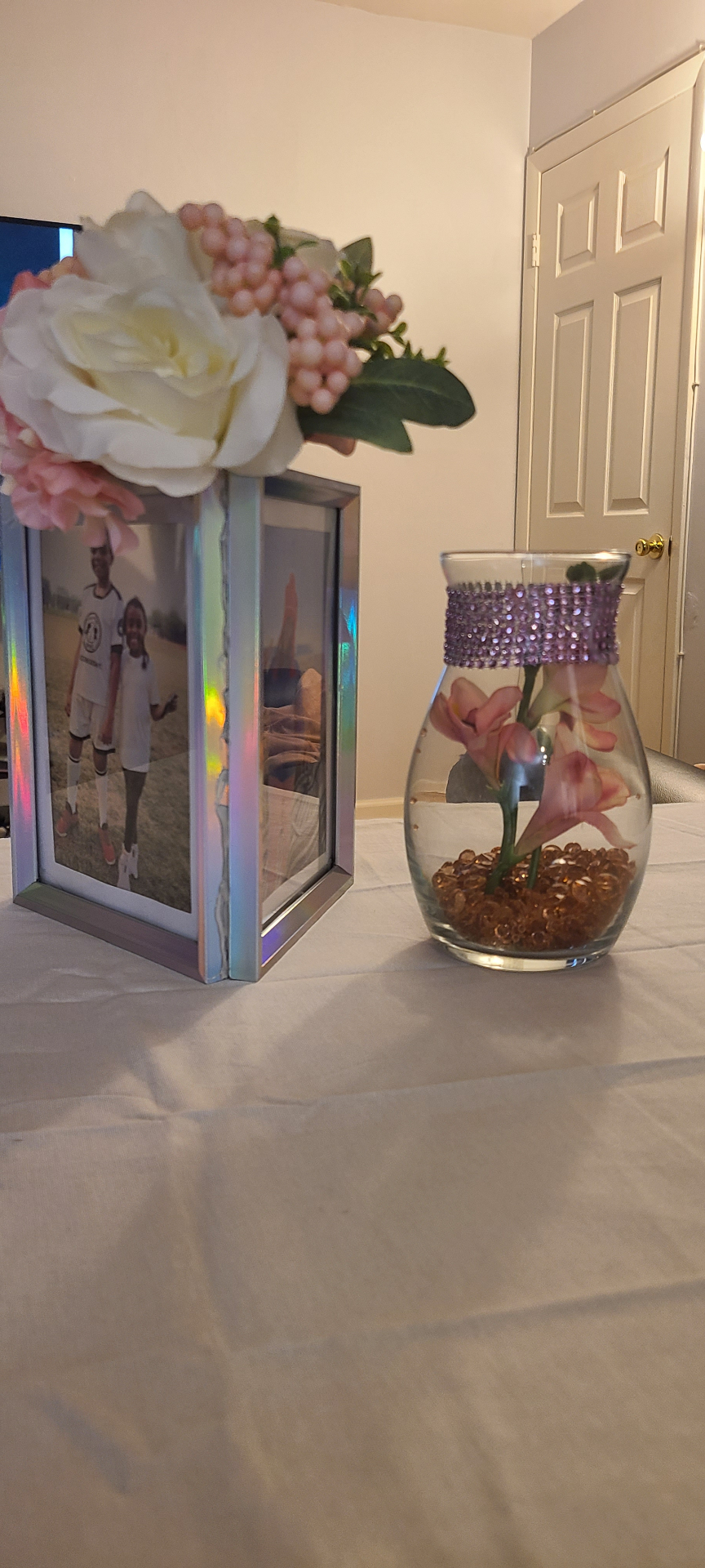 Iridescent photo frame centerpiece with pink florals and glass vase styled by Simone's Creations DMV