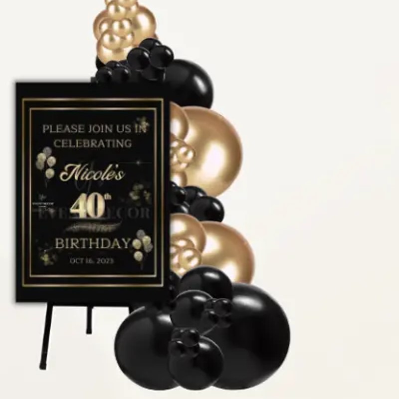 Custom black and gold welcome sign on easel with balloon garland