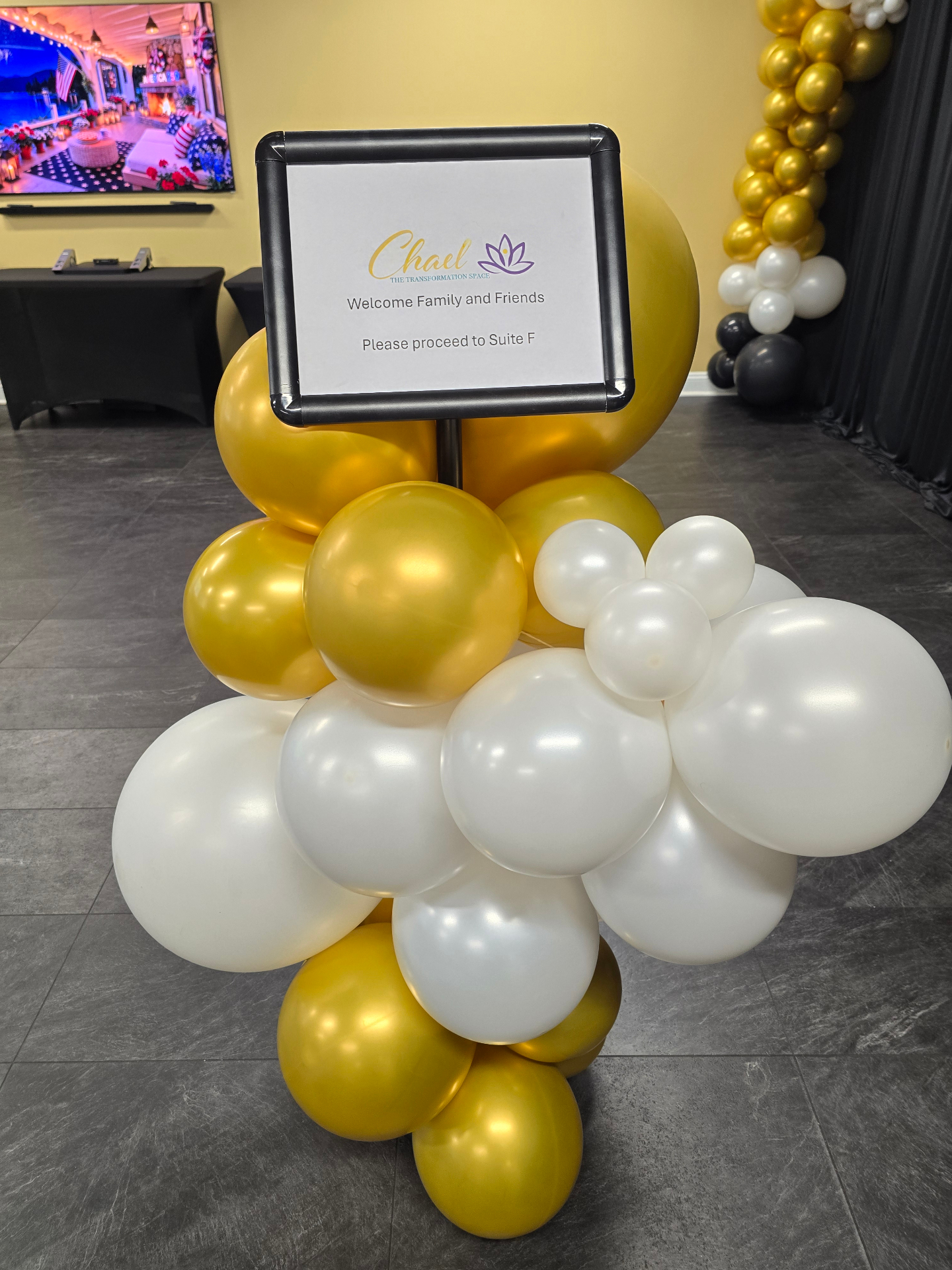 Gold and white welcome sign balloon cluster on stand by Simone's Creations DMV