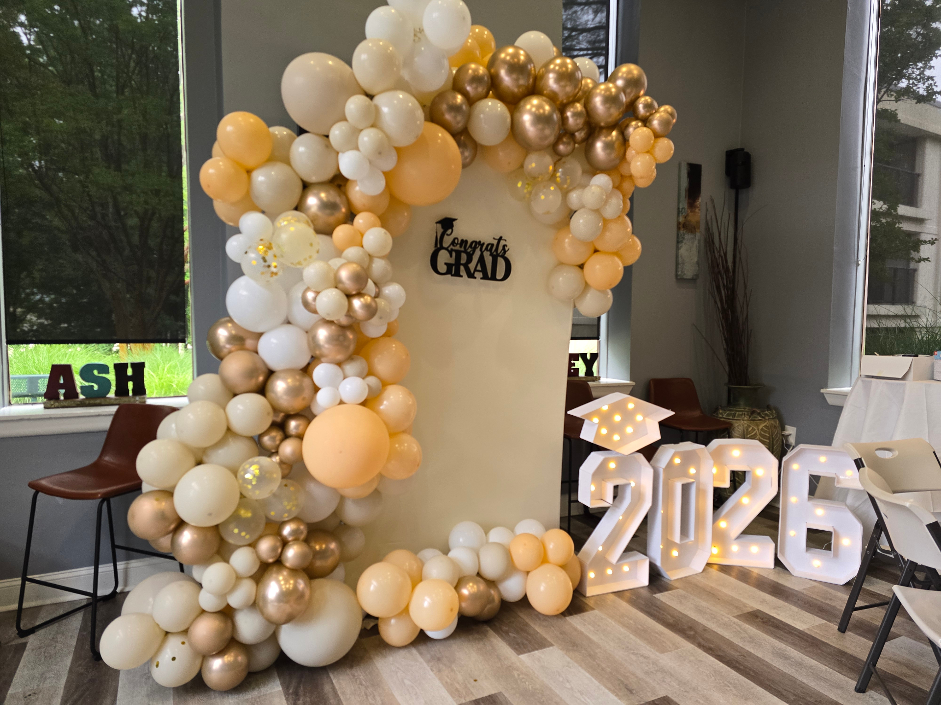Graduation framed photo moment with cream and gold balloon garland by Simone's Creations DMV