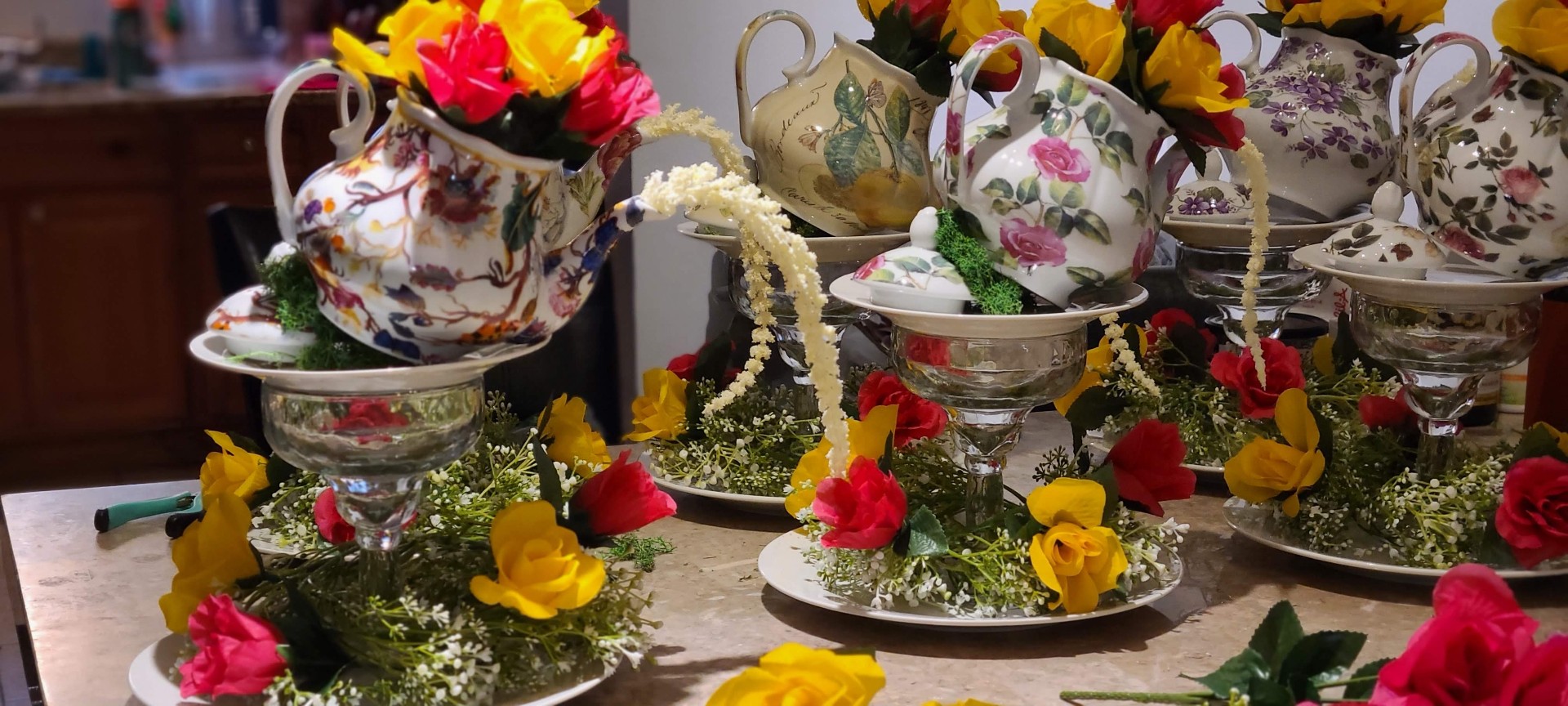 Floating teapot floral centerpieces with pouring baby's breath and roses by Simone's Creations DMV