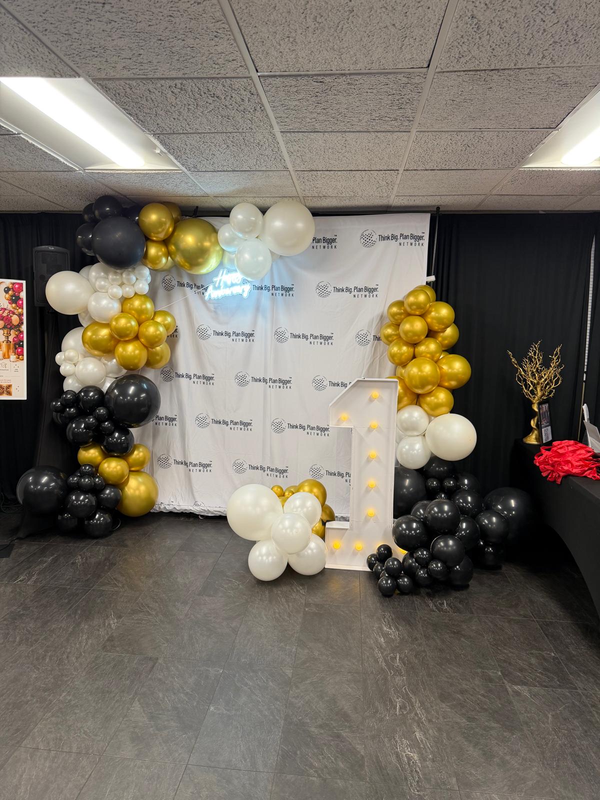 Black, gold and white anniversary balloon garland backdrop by Simone's Creations DMV