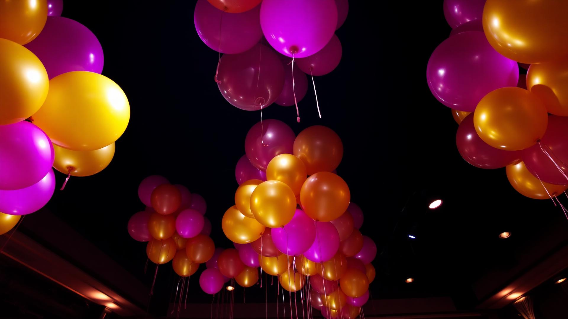 Dramatic luxury balloon installation in fuchsia and gold